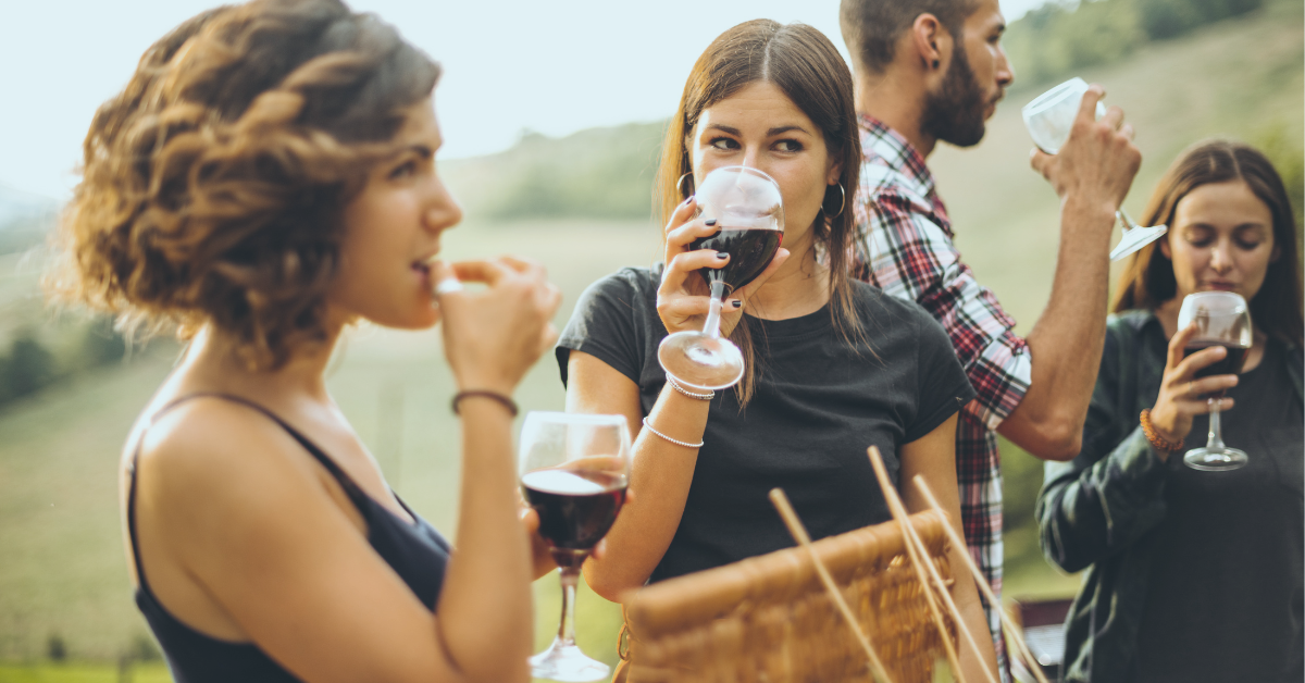 Picture of people standing and drinking red wine affects of coffee and wine on your teeth