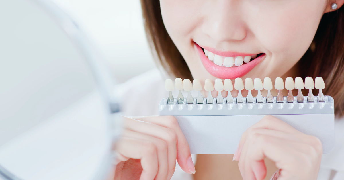 A patient at Saskatoon Dental Group deciding what color of teeth she wants her teeth whitened too. 