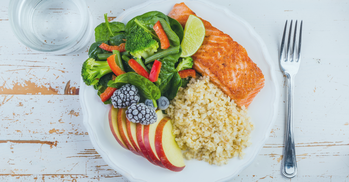 A plate of healthy food, vegetables, fruit and fish Saskatoon Dental Group Blog What do you eat for healthy teeth?