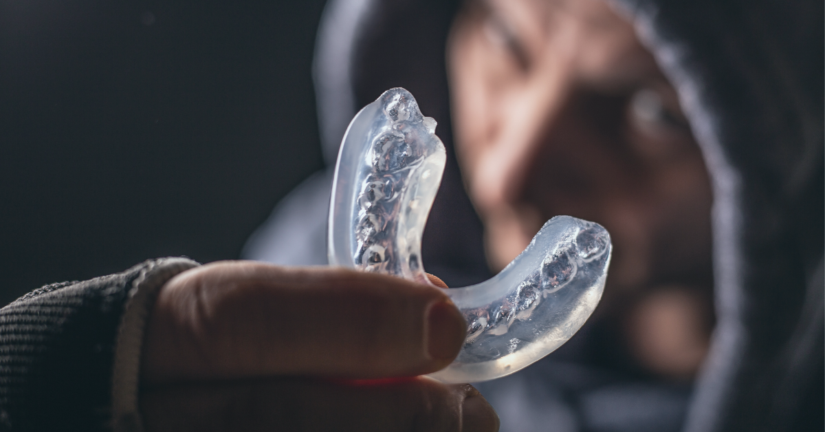a person holding up a mouthguard the importance of  mouthguards saskatoon dental group mar blog