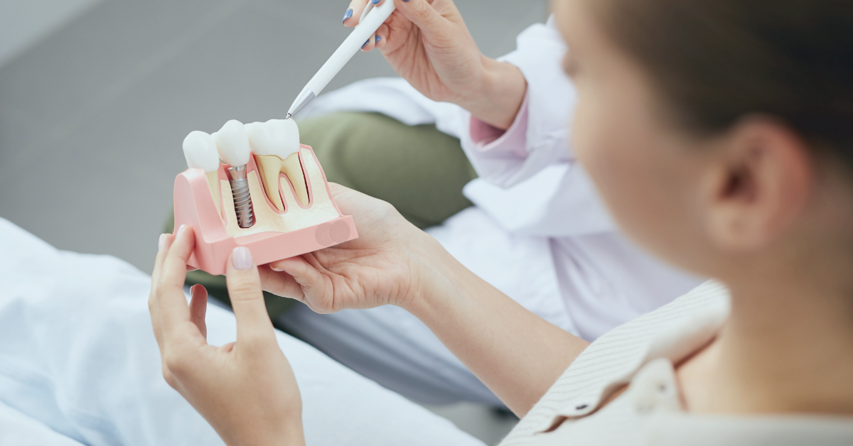 women looking at model of teeth while dentist explains the care tips following minor oral surgery at saskatoon dental group